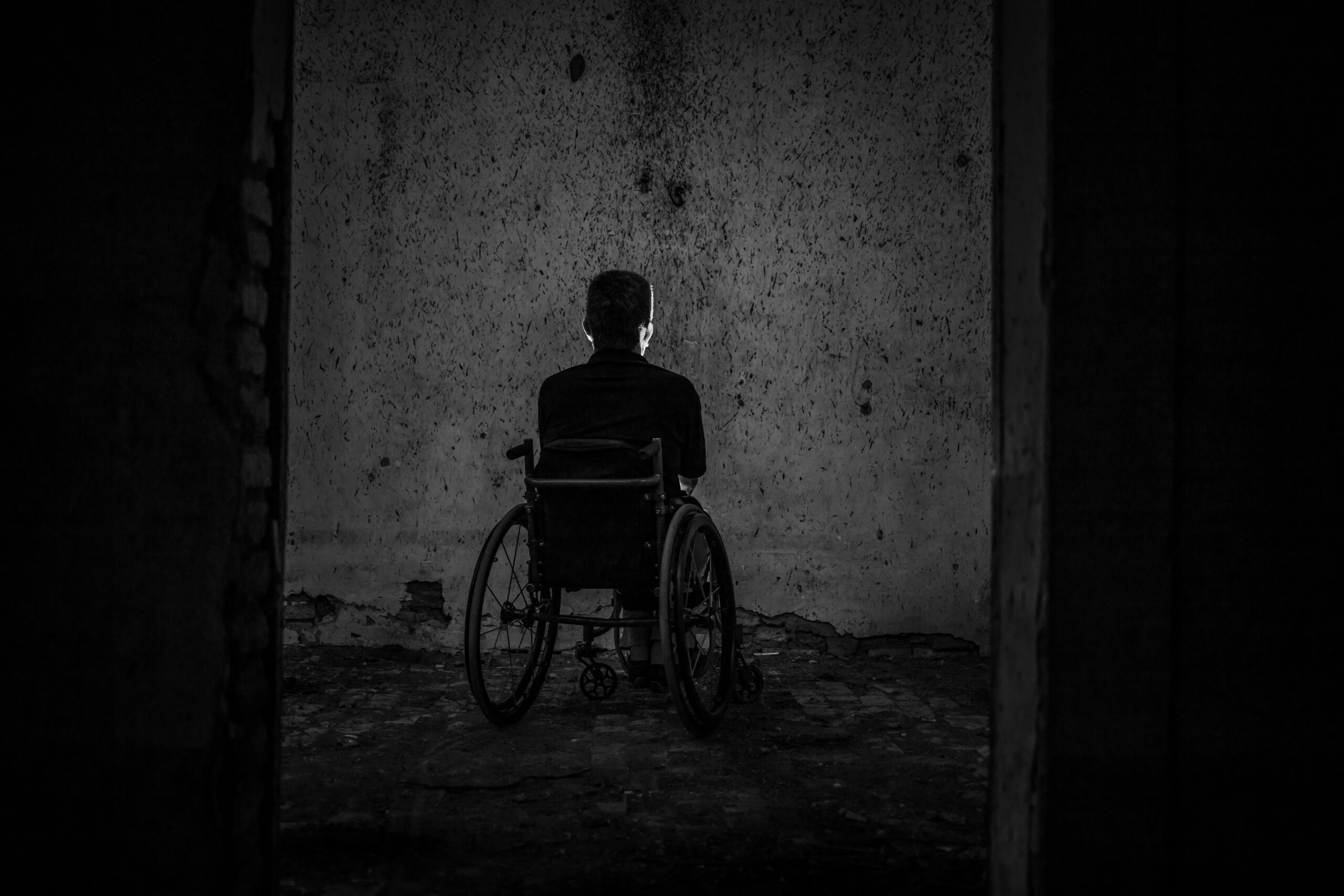 osoba u invalidskim kolicima u mračnoj prostoriji